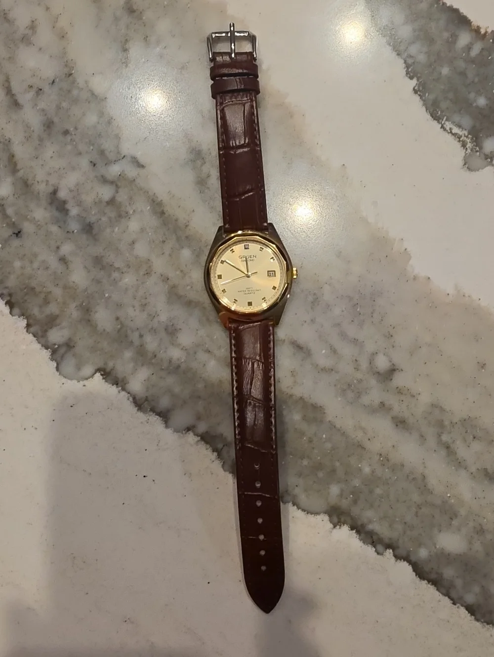 Vintage Gruen Diamond Quartz watch with a gold-tone case, date window at 3